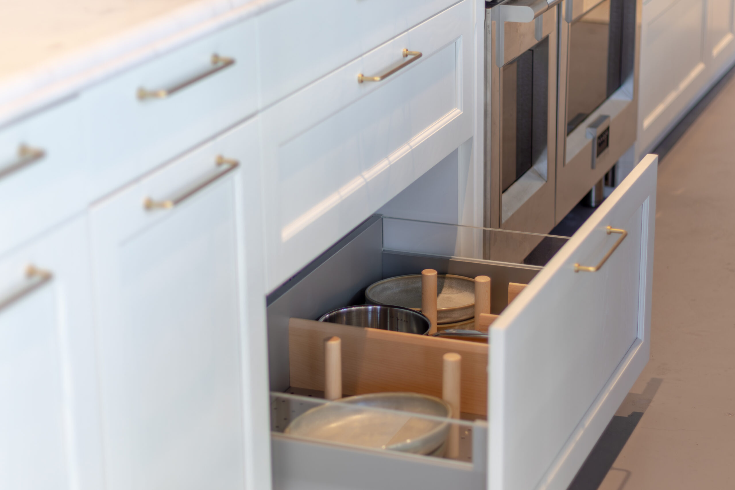 Open kitchen drawer with plate organiser and cookware
