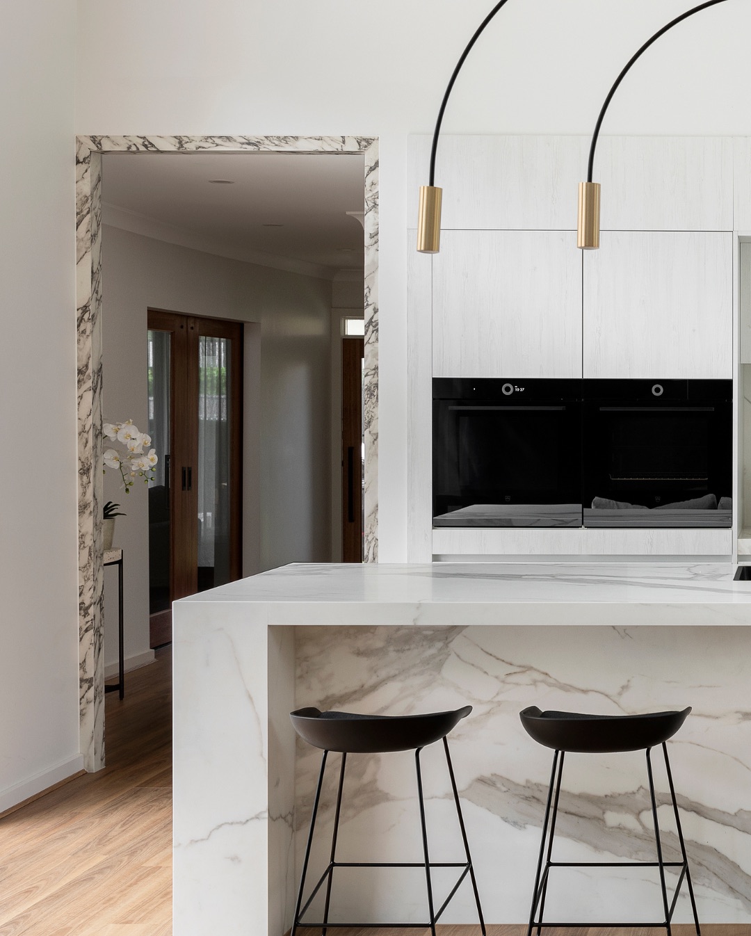 Luxury Häcker kitchen island with waterfall marble stone benchtop and white premium cabinetry